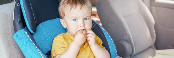 child in car seat eating food