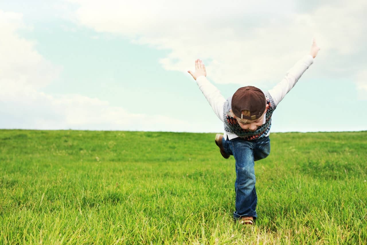 boy running in field